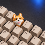 Corgi Charm orange resin keycap installed on a cream keyboard. Keyboard and other keycaps are not included.
