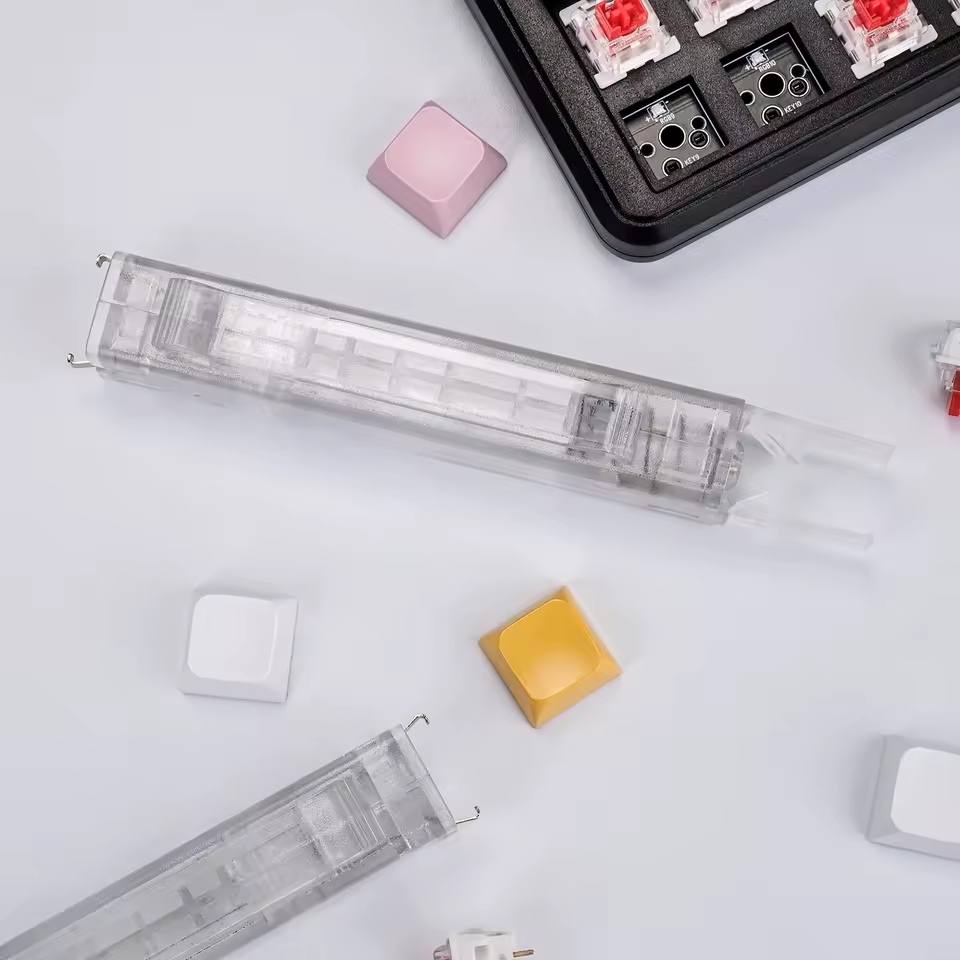 Reverse view of the transparent Clear Lift tool with its metal hooks and plastic removal end. Additional tools, keyboard and loose parts are not included. Supplier photo.