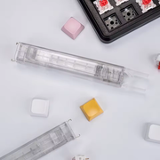 Reverse view of the transparent Clear Lift tool with its metal hooks and plastic removal end. Additional tools, keyboard and loose parts are not included. Supplier photo.