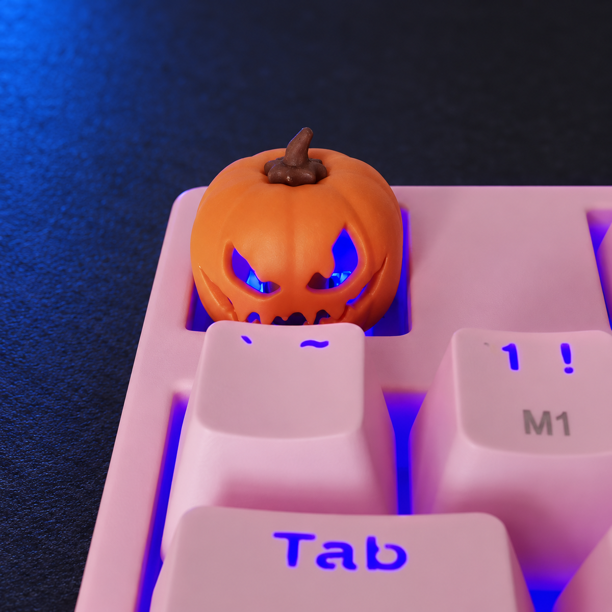 Pumpkin Glow keycap installed on a pink keyboard with purple lighting. Keyboard and lighting are not included.