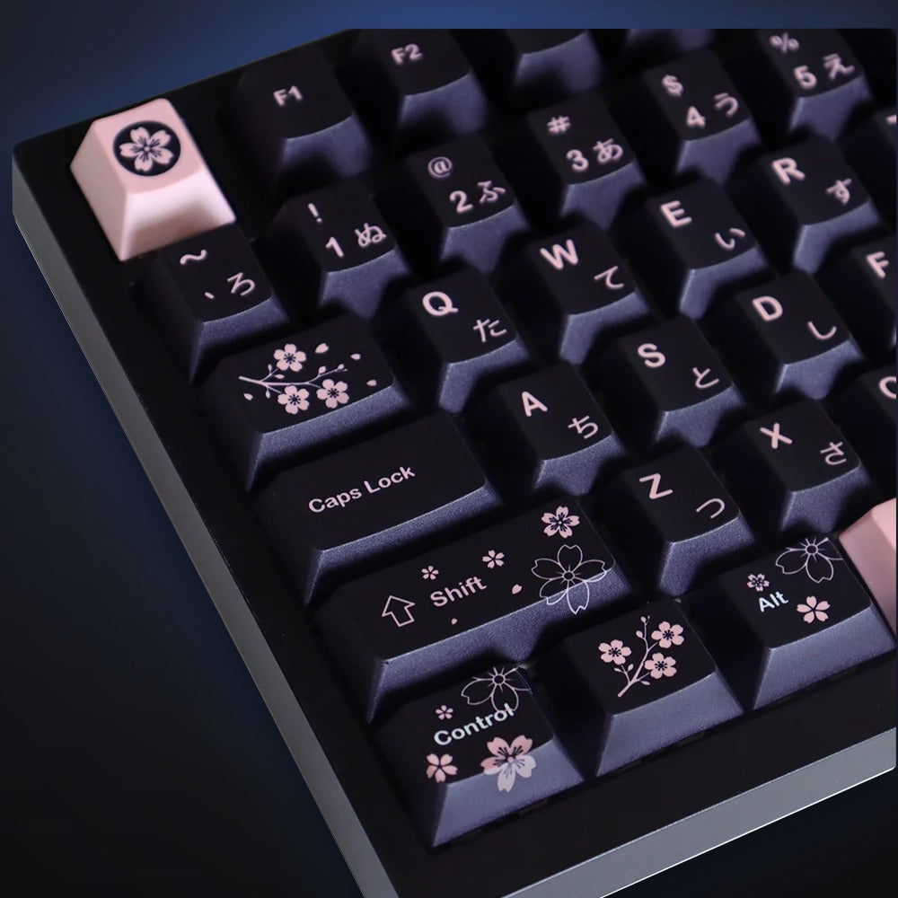 Close-up of Torii Spring black keycaps with cherry blossom details. Keyboard not included.