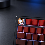 Molten Gold accent keycap installed among red keyboard keys. Keyboard and other keys are not included.
