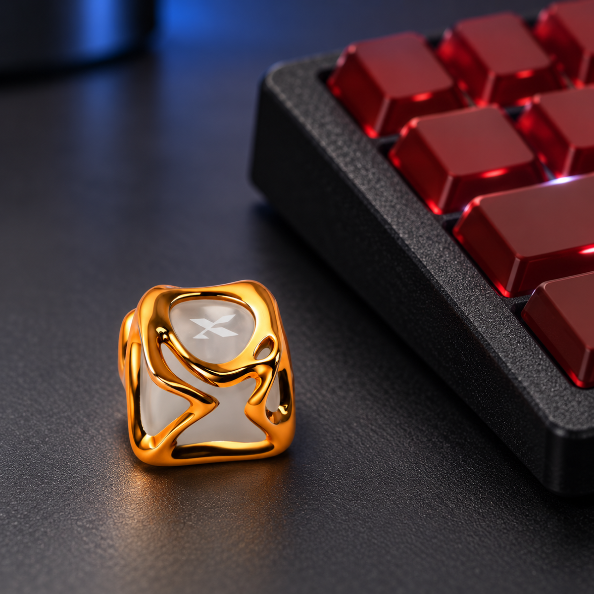 Molten Gold sculpted keycap on a charcoal desk with a keyboard behind. One keycap is included.